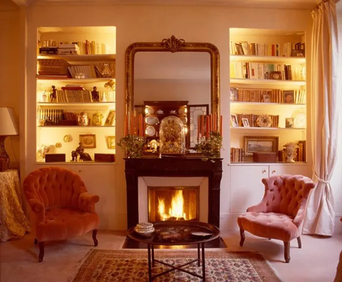 Framed Print : Lighted alcove shelves on either side of fireplace with lighted fire in living room with pink velvet chairs Framed Print : Lighted alcove shelves on either side of fireplace with lighted fire in living room with pink velvet chairs
