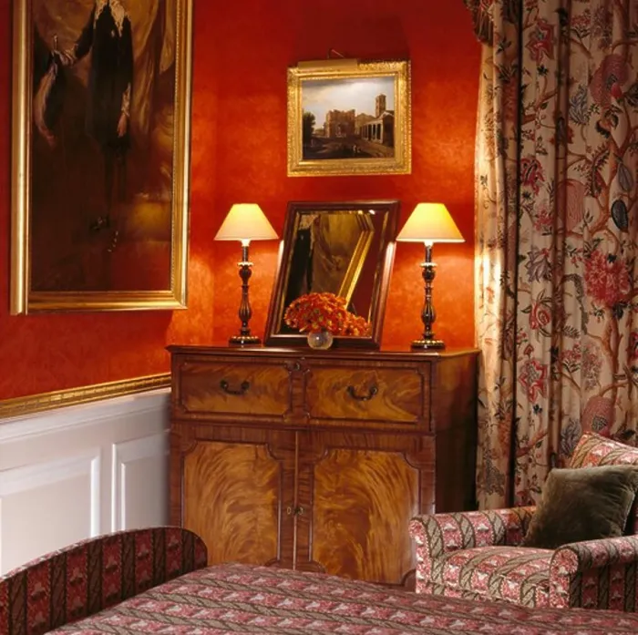 Framed Print : Lighted lamps on antique cupboard in red bedroom with patterned curtain Framed Print : Lighted lamps on antique cupboard in red bedroom with patterned curtain