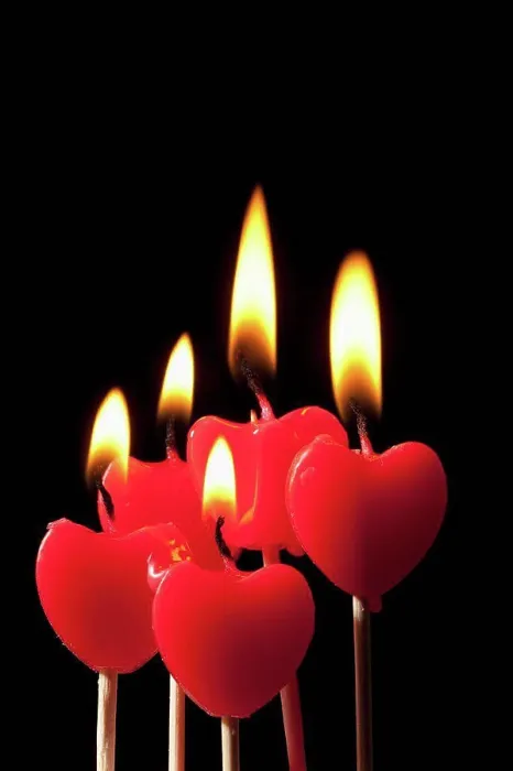 Framed Print : Five lit heart shaped candles on sticks arranged in a group Framed Print : Five lit heart shaped candles on sticks arranged in a group