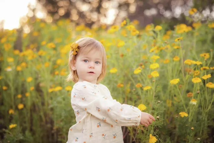 Framed Print : Little girl picking a yellow flower Framed Print : Little girl picking a yellow flower