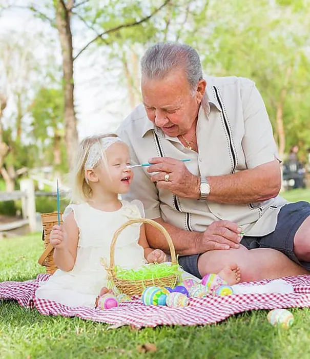 Framed Print : Loving grandfather and granddaughter coloring easter eggs together on picnic blanket at the park Framed Print : Loving grandfather and granddaughter coloring easter eggs together on picnic blanket at the park