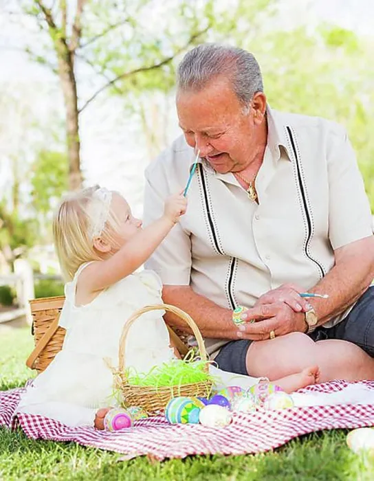 Framed Print : Loving grandfather and granddaughter coloring easter eggs together on picnic blanket at the park Framed Print : Loving grandfather and granddaughter coloring easter eggs together on picnic blanket at the park