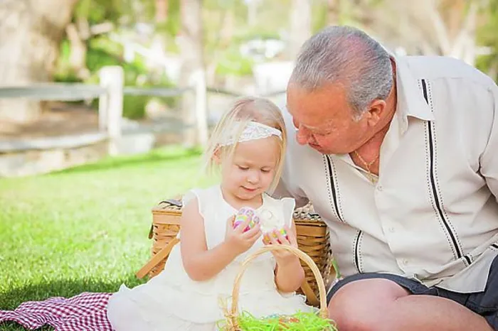 Framed Print : Loving grandfather and granddaughter enjoying easter eggs on a picnic blanket at park Framed Print : Loving grandfather and granddaughter enjoying easter eggs on a picnic blanket at park