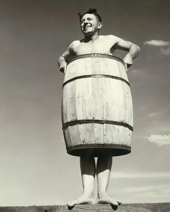 Framed Print : Low angle view of a young man wearing a barrel