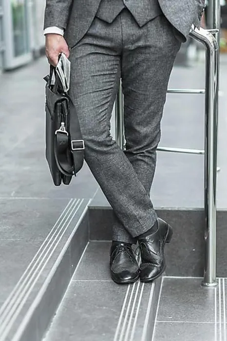Framed Print : Low section view businessman holding shoulder bag Framed Print : Low section view businessman holding shoulder bag