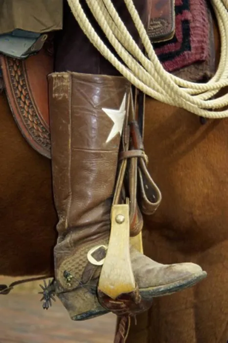 Framed Print : Low section view of a cowboy riding a horse