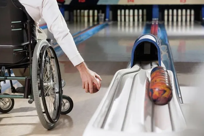 Framed Print : Low section view of a man with a Spinal Cord Injury playing ten pin bowling Framed Print : Low section view of a man with a Spinal Cord Injury playing ten pin bowling