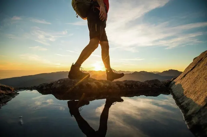 Framed Print : Lower half of backpacker walking on summit ridge