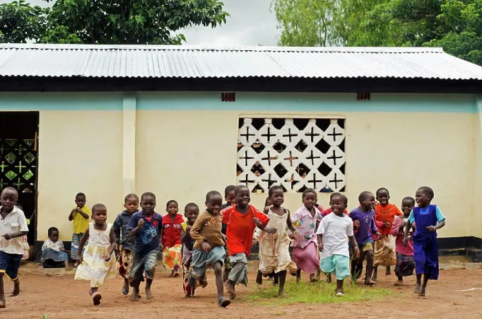 Framed Print : Malawi, Mzimba district, Chilumba Community Based Childcare Centre (CBCC). Children running in front of building Framed Print : Malawi, Mzimba district, Chilumba Community Based Childcare Centre (CBCC). Children running in front of building