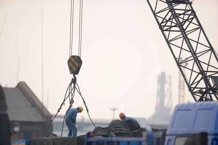 Framed Print : Two male construction workers hooking cables to a crane in a shipping yard Framed Print : Two male construction workers hooking cables to a crane in a shipping yard
