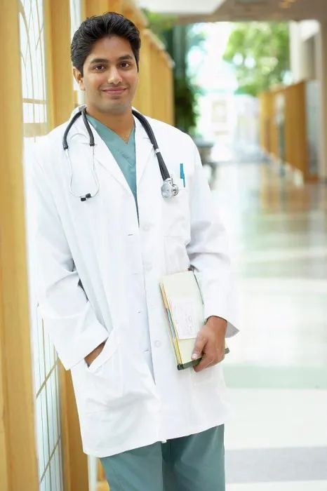 Framed Print : Male doctor standing in a corridor Framed Print : Male doctor standing in a corridor