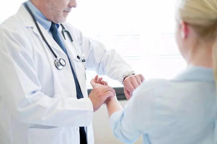 Framed Print : Male doctor taking patient's pulse Framed Print : Male doctor taking patient's pulse