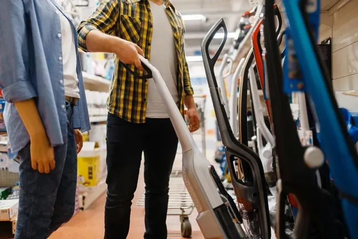 Framed Print : Male person hand holds vacuum cleaner in electronics store Framed Print : Male person hand holds vacuum cleaner in electronics store