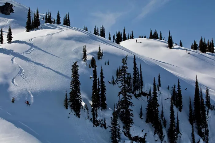 Framed Print : A male skier earns his turns and skis fresh powder while ski touring