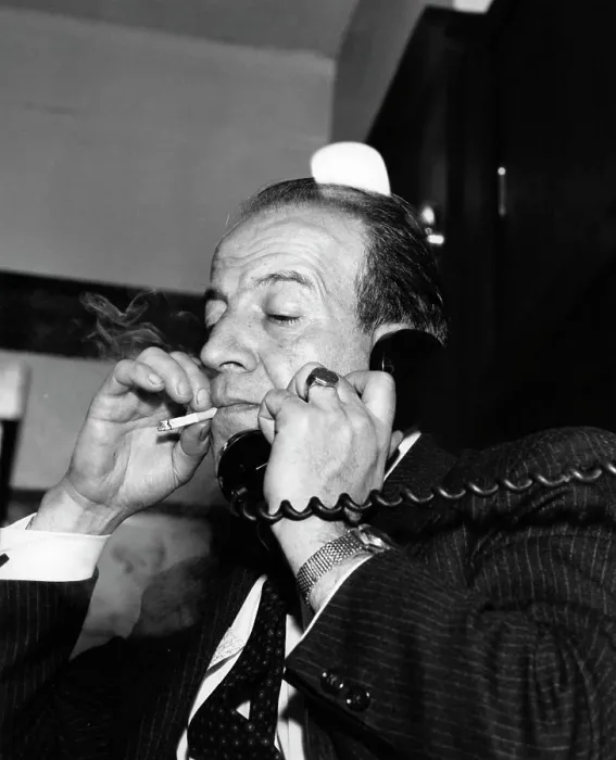 Framed Print : Man with cigarette talking on phone