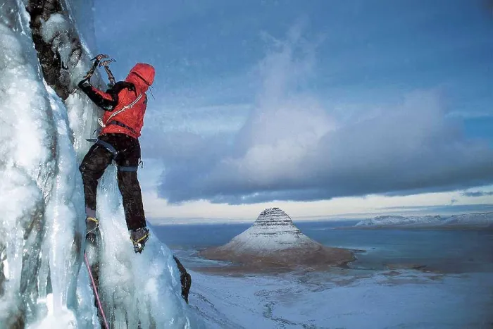 Framed Print : man climbs frozen waterfall above Grundafjordur fjord in Iceland Framed Print : man climbs frozen waterfall above Grundafjordur fjord in Iceland