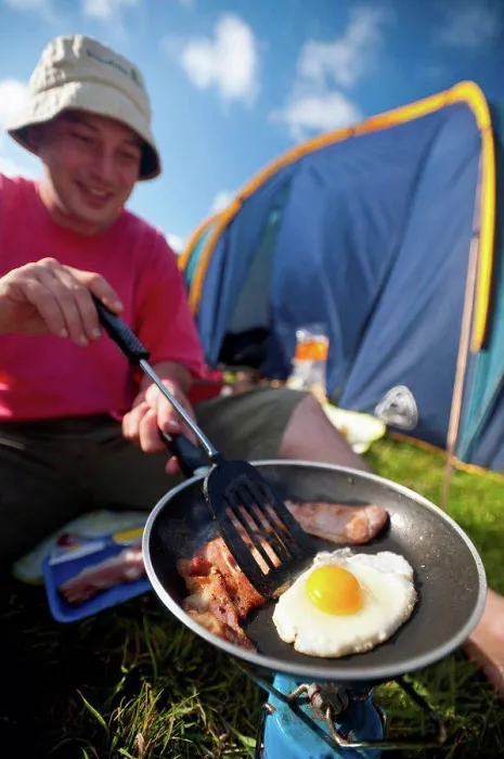 Framed Print : Man cooking fried breakfast of bacon and egg beside tent; Lulworth, Dorset, UK Framed Print : Man cooking fried breakfast of bacon and egg beside tent; Lulworth, Dorset, UK