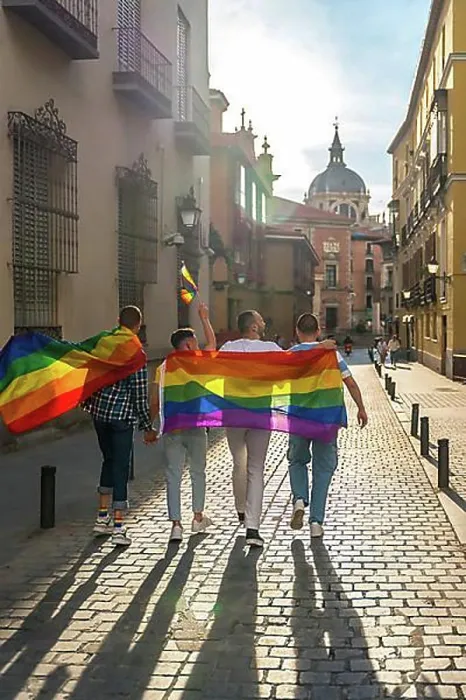 Framed Print : Man with his back facing the demonstration with the rainbow flags, gay pride party in the city, lgbt concept Framed Print : Man with his back facing the demonstration with the rainbow flags, gay pride party in the city, lgbt concept