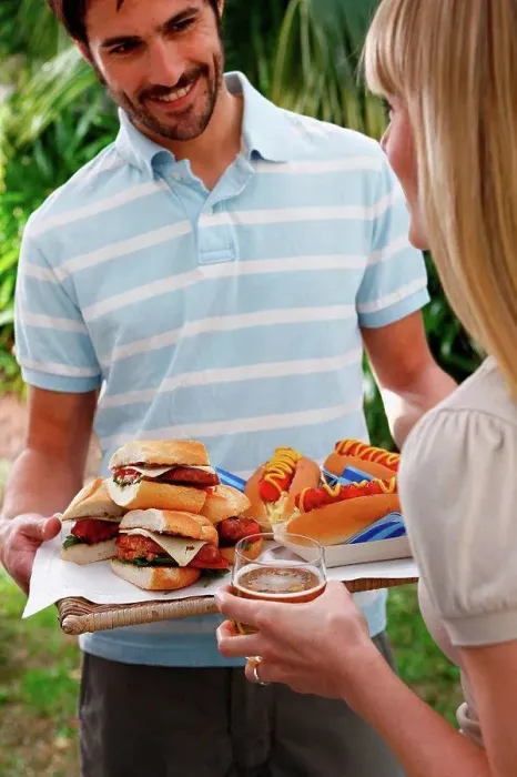 Framed Print : Man holding tray of burgers and hot dogs Framed Print : Man holding tray of burgers and hot dogs