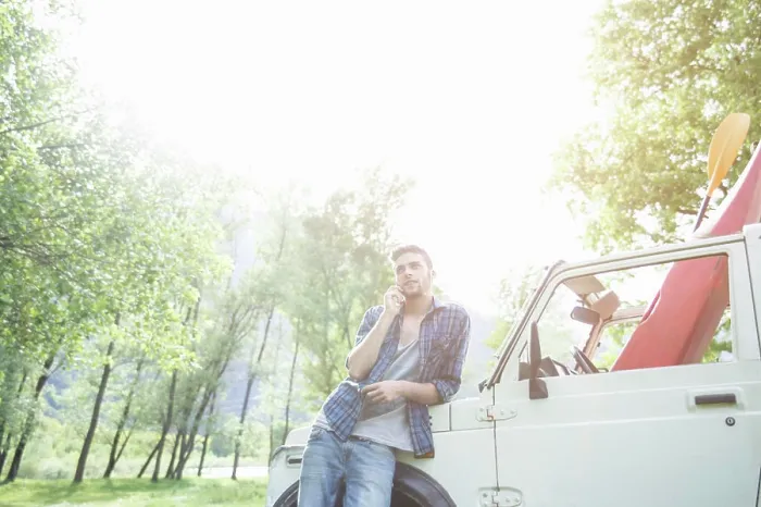 Framed Print : Man leaning on his vehicle during a sunny outdoor adventure
