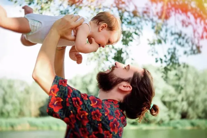 Framed Print : Man lifting up baby girl by lake, Arezzo, Tuscany, Italy