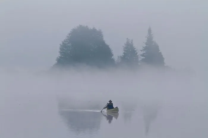Framed Print : Man paddles solo canoe on Oxtongue Lake, Muskoka, Ontario Framed Print : Man paddles solo canoe on Oxtongue Lake, Muskoka, Ontario