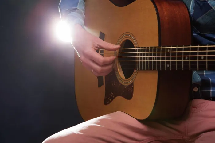Framed Print : Man playing on acoustic guitar Man playing on acoustic guitar on dark background Copyright: xZoonar