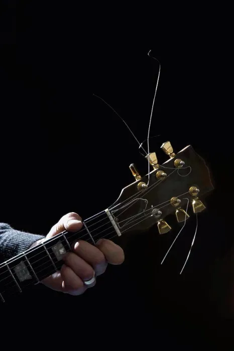 Framed Print : Detail of a man playing an electric guitar