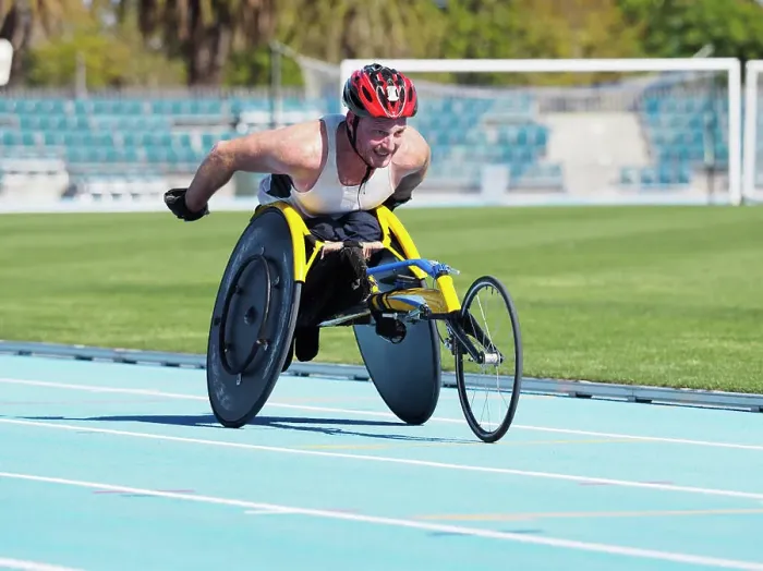 Framed Print : Man racing in wheelchair on track