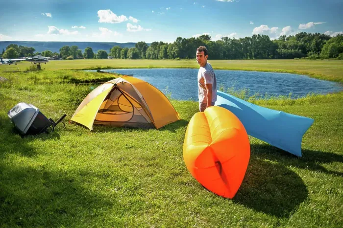 Framed Print : Man setting up Inflatable sofas out in the wild camping in summer Framed Print : Man setting up Inflatable sofas out in the wild camping in summer