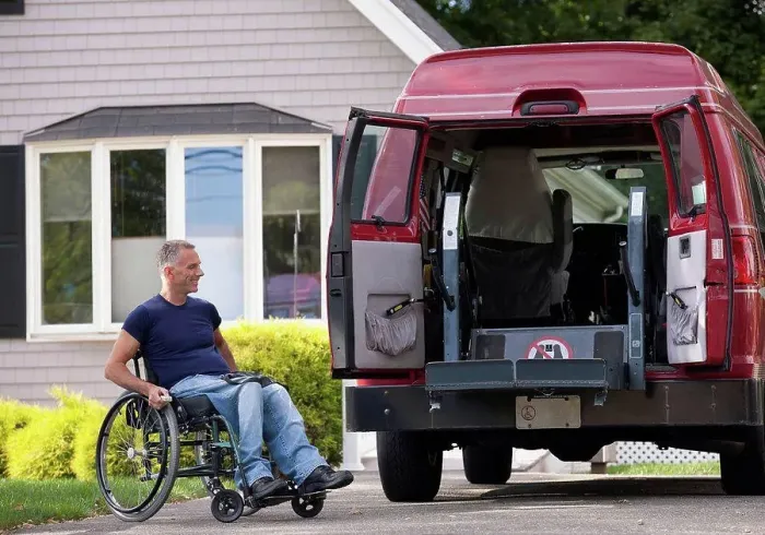 Framed Print : Man with spinal cord injury in a wheelchair getting in his accessible van Framed Print : Man with spinal cord injury in a wheelchair getting in his accessible van