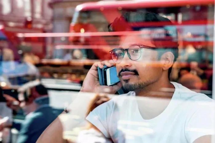 Framed Print : Man using smartphone in cafe Framed Print : Man using smartphone in cafe