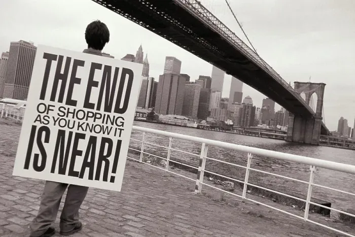 Framed Print : Man wearing placard saying THE END OF SHOPPING AS YOU KNOW IT IS NEAR! and looking out at Manhattan