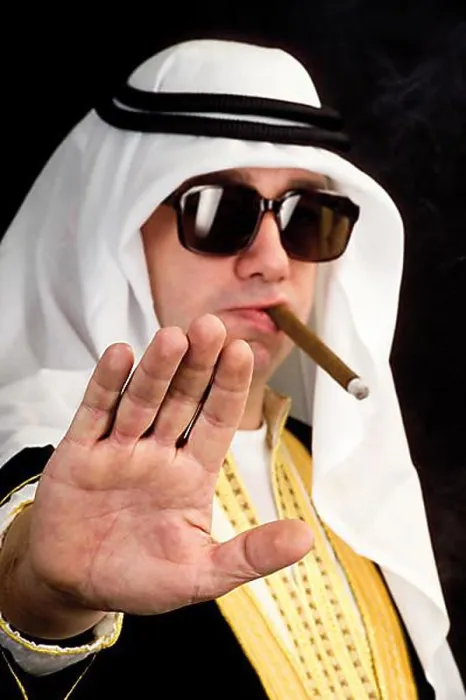 Framed Print : Man wearing a Sheikh costume and smoking a cigar
