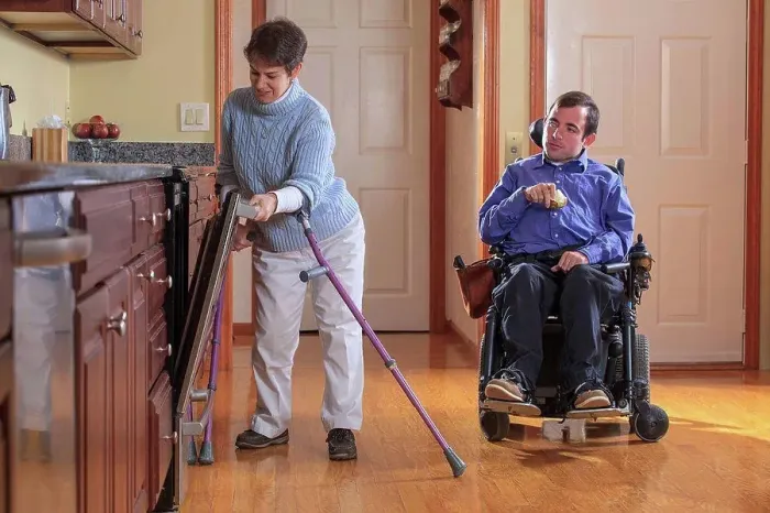 Framed Print : Man and woman with Cerebral Palsy preparing for lunch and using the dishwasher in their home kitchen Framed Print : Man and woman with Cerebral Palsy preparing for lunch and using the dishwasher in their home kitchen