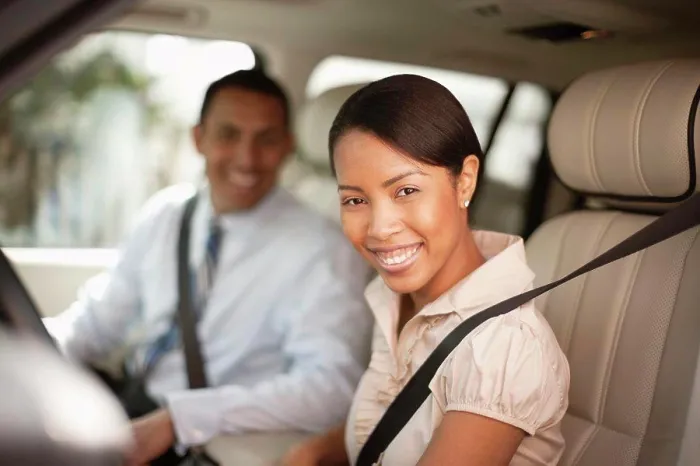 Framed Print : Man and woman sitting in car smiling at the camera Framed Print : Man and woman sitting in car smiling at the camera
