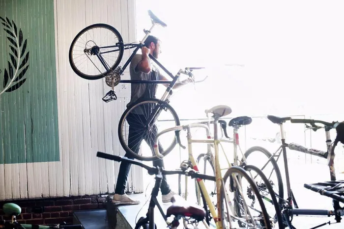 Framed Print : A man working in a bicycle repair shop Framed Print : A man working in a bicycle repair shop