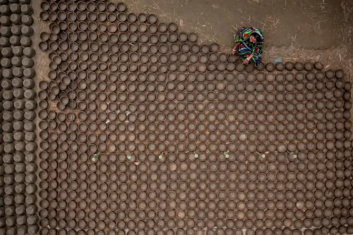 Framed Print : Manikgonj, Bangladesh - 20 February 2022: Aerial view of a woman working with clay pot in Manikgonj, Dhaka, Bangladesh Framed Print : Manikgonj, Bangladesh - 20 February 2022: Aerial view of a woman working with clay pot in Manikgonj, Dhaka, Bangladesh