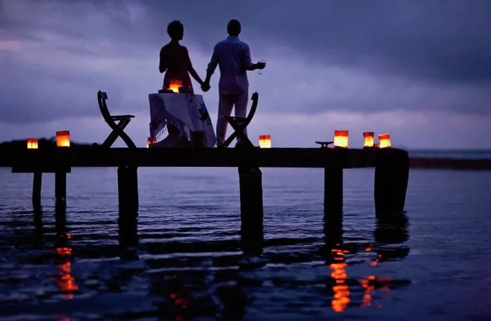 Framed Print : Mature couple enjoying their date on the pier at twilight Framed Print : Mature couple enjoying their date on the pier at twilight