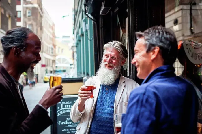 Framed Print : Three mature men, standing outside pub, holding beer glasses, laughing Framed Print : Three mature men, standing outside pub, holding beer glasses, laughing