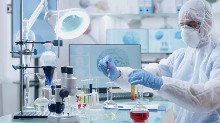 Framed Print : Microbiologist scientist researcher mixing medical solution developing vaccine Framed Print : Microbiologist scientist researcher mixing medical solution developing vaccine