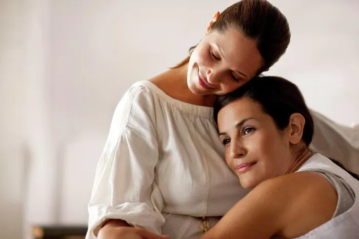 Framed Print : Mid-adult lesbian couple intimately relaxing together