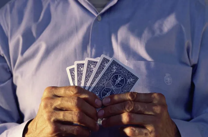 Framed Print : Mid section view of a man holding playing cards Framed Print : Mid section view of a man holding playing cards