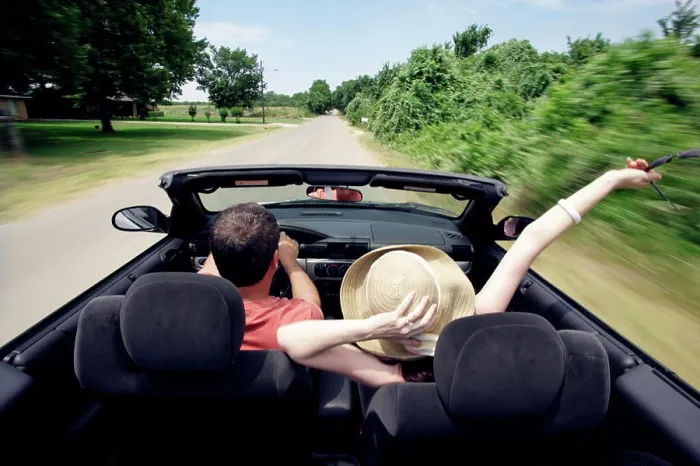 Framed Print : Middle aged baby boomer couple driving down country road in convertible with top down Framed Print : Middle aged baby boomer couple driving down country road in convertible with top down
