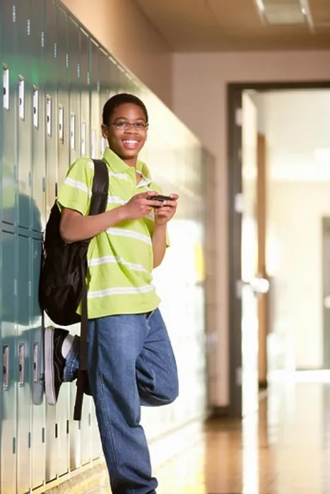 Framed Print : Middle school student text messaging on a mobile phone