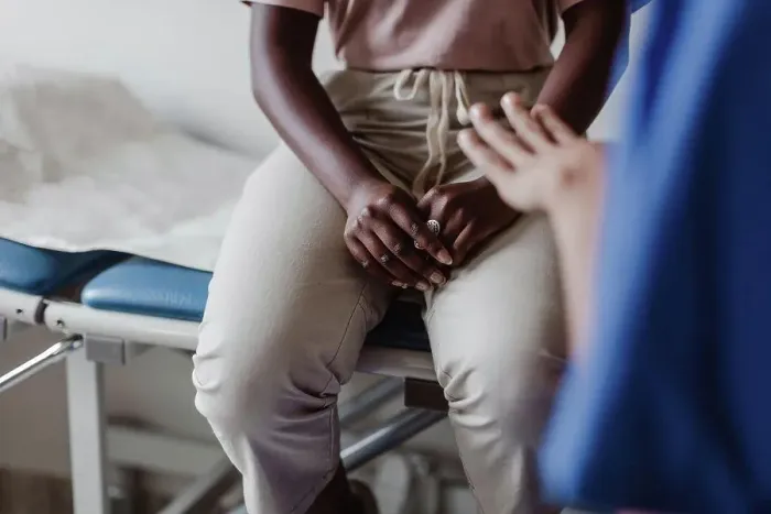 Framed Print : Midsection of female healthcare worker explaining to young patient in medical clinic Framed Print : Midsection of female healthcare worker explaining to young patient in medical clinic