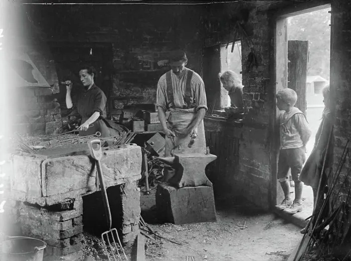Framed Print : Ministry of Information First World War Official Collection Woman helping her blacksmith husband in his forge