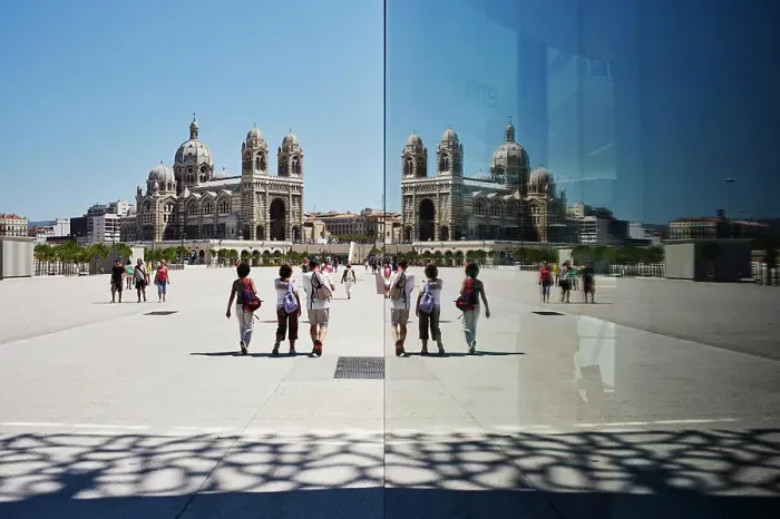 Framed Print : Mirror reflection of tourists and Marseille cathedral, Marseille, France