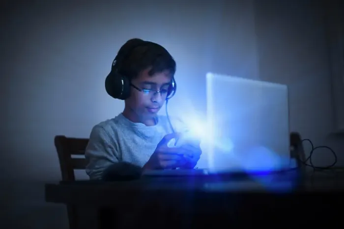 Framed Print : Mixed Race boy using cell phone and laptop Framed Print : Mixed Race boy using cell phone and laptop
