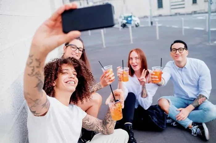 Framed Print : Mixed race group of friends hanging out together in town, taking selfie with mobile phone Framed Print : Mixed race group of friends hanging out together in town, taking selfie with mobile phone